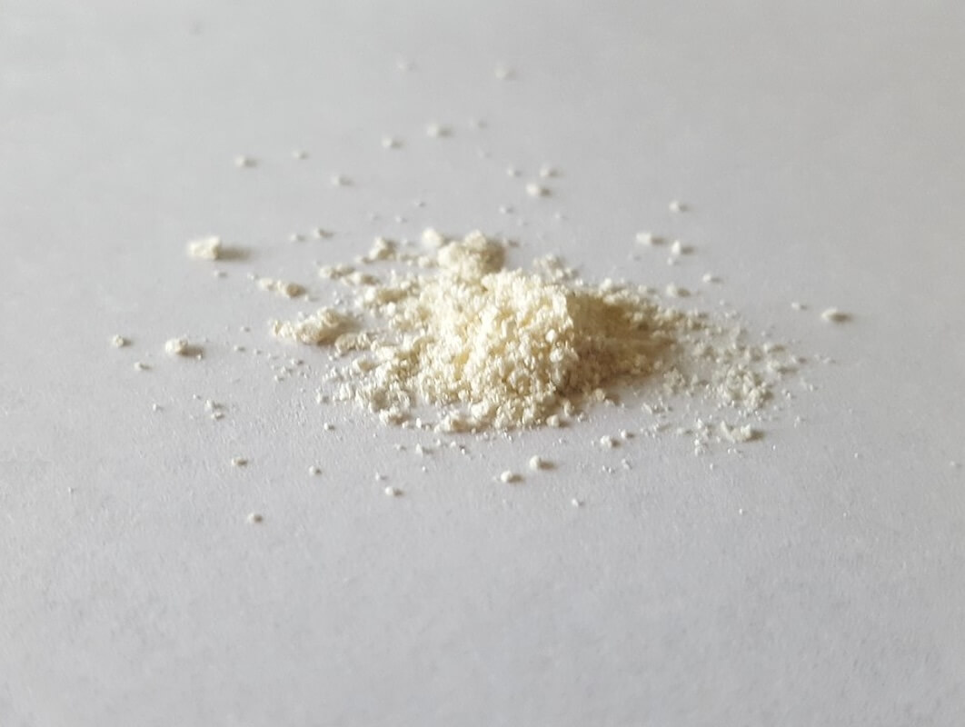 Pile of white fentanyl powder on table demonstrating danger of allowing undocumented persons to come across the southern US border with the potential risk of fentanyl entering the country